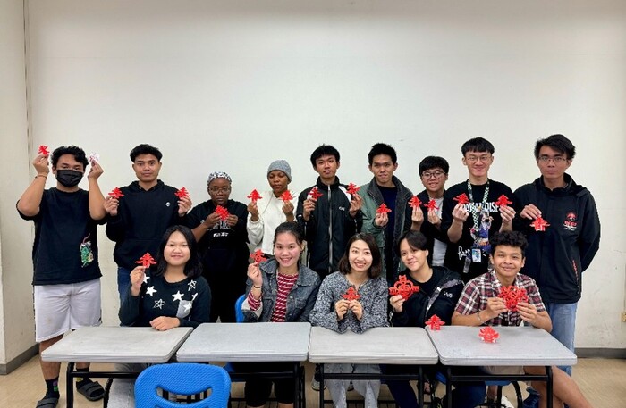 Students of the International Foundation Program experience the art of paper cutting during a Lunar New Year cultural class.